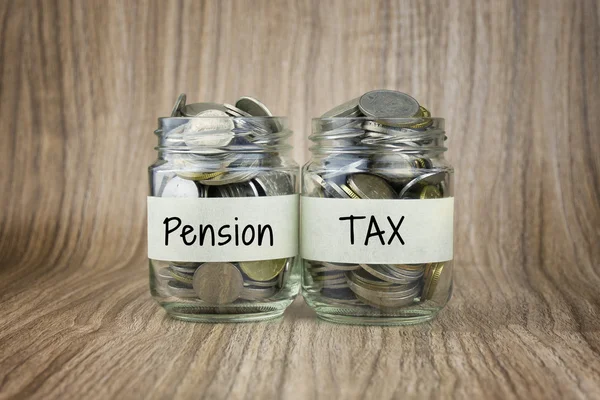 Two glass jars with coins labeled Pension and TAX. Financial Conceptual — Stock Photo, Image