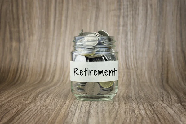 Glass jars with coins labeled Retirement. Financial Conceptual — Stock Photo, Image