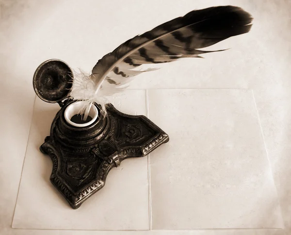 Antique brass inkwell with feather — Stock Photo, Image