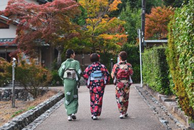 Japonya 'nın Kyoto şehrinde kimono giyen kadınlar yürüyor. Kyoto, Japonya 'nın kültürel başkenti ve önemli bir turizm merkezi olarak kabul edilir..