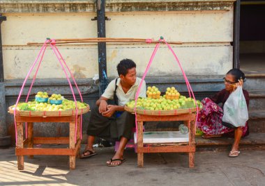 Burmese women selling fresh fruits at Bogyoke market clipart