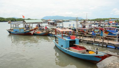 Tourists waiting at the pier for boarding to boat
