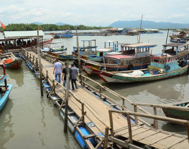Tourists waiting at the pier for boarding to boat