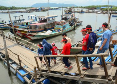 Tourists waiting at the pier for boarding to boat