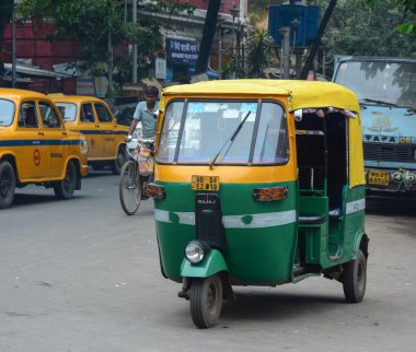 Rickshaw three-weeler tuk-tuk on the street in Kolkata clipart