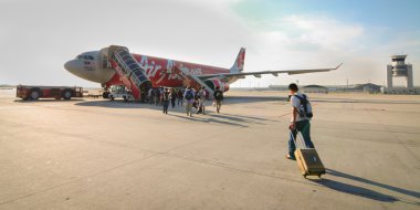 Passengers boarding to AirAsia airplane at KLIA2