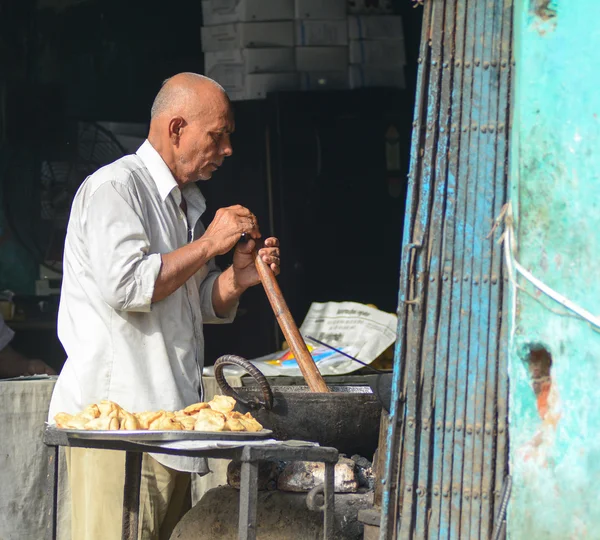 Indian man selling street foods in Delhi