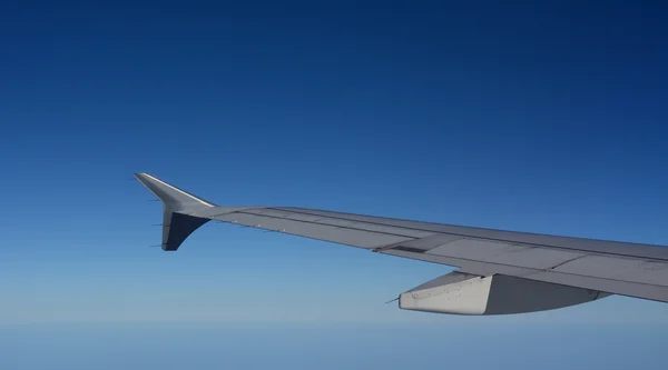 Vleugel van het vliegtuig dat boven de wolken vliegt — Stockfoto