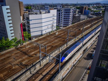 Kanazawa, Japonya - 1 Mayıs 2023. Kanazawa City, Japonya 'dan geçen elektrikli bir trenin bulunduğu raylar..