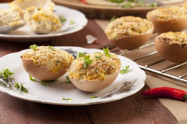 Baked eggs, stuffed with ham and parsley — Stock Photo, Image