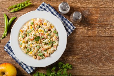 Mayonezli sebzeli geleneksel salata. Ahşap arka plan. Üst görünüm.