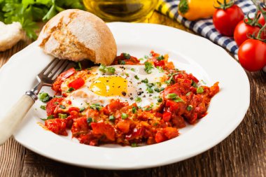 Shakshouka, domates sosunda haşlanmış yumurta, acı biber, soğan. Ön görünüm. 