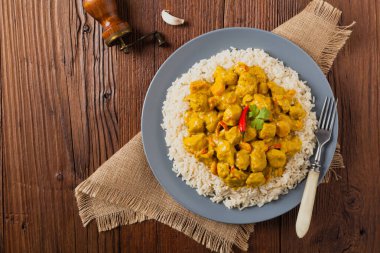 Körili tavuk sosu. Pirinçle servis edilmiş. Üst Manzara. Doğal ahşap zemin.