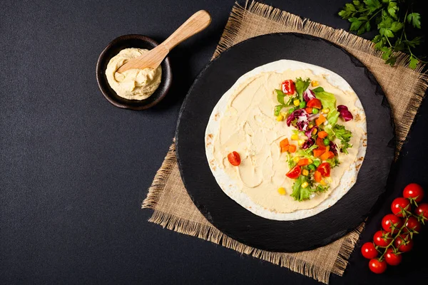Tortilla Met Groenten Hummus Met Kikkererwten Bovenaanzicht Zwarte Achtergrond — Stockfoto
