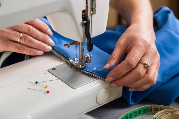 Sewing workshop. Sewing zipper on sewing machine.