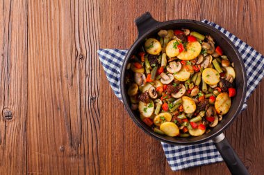 Kızarmış tava sebze, mantarlı ve kurutulmuş domatesli. Baharatlı bitki karışımı.