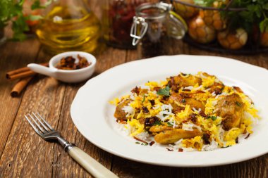 Biryani ve tavuk. Geleneksel Hint yemeği ve baharat ve yoğurt ile marine edilmiş tavuk. Ön manzara. Doğal ahşap arka plan. 