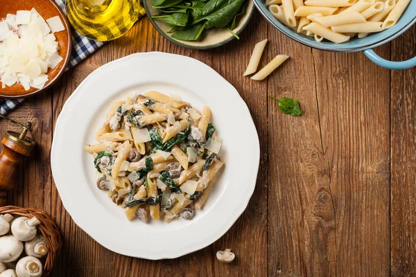 Penne Pasta Met Spinazie Champignons Bestrooid Met Kaas Bovenaanzicht — Stockfoto