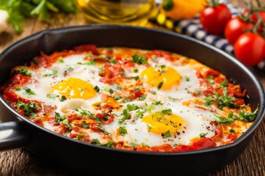 Shakshouka, domates sosunda haşlanmış yumurta, acı biber, soğan. Ön görünüm. 
