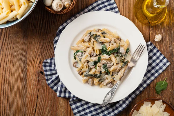 Penne Pasta Met Spinazie Champignons Bestrooid Met Kaas Bovenaanzicht — Stockfoto