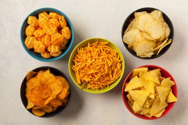 Bowls with snacks like chips, crisps, popcorn. Perfect for a party. Top view. clipart