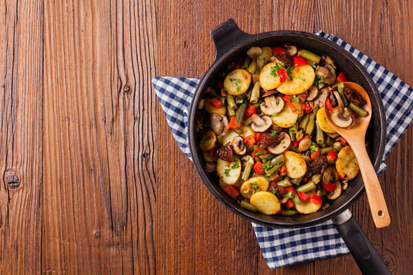 Fried pan vegetables, with mushrooms and dried tomatoes. Seasoned with a mix of herbs