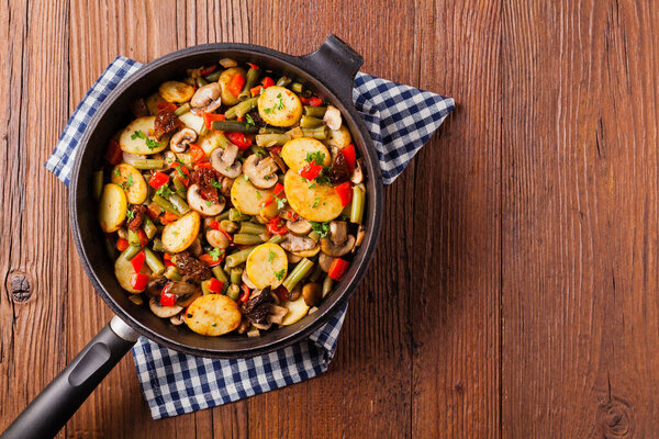 Fried pan vegetables, with mushrooms and dried tomatoes. Seasoned with a mix of herbs