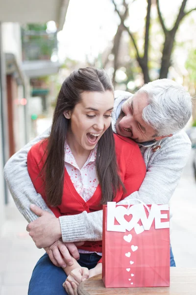 Man surprising woman with present — Stock Photo, Image