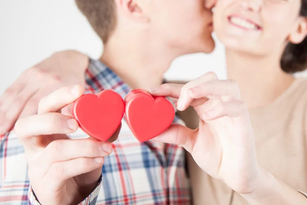 Happy couple holding red hearts — Stock Photo, Image