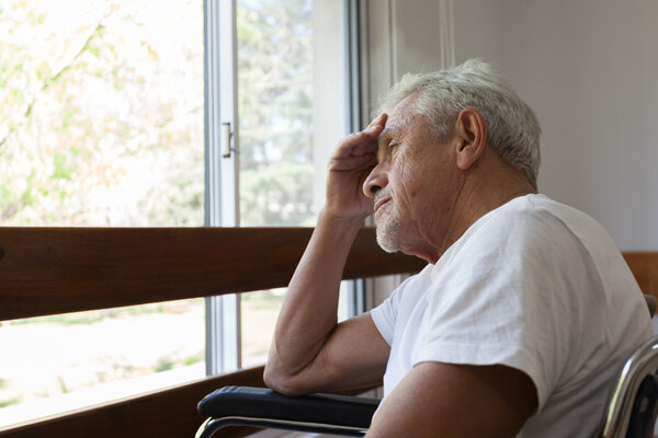 Man on a wheelchair looking for a window