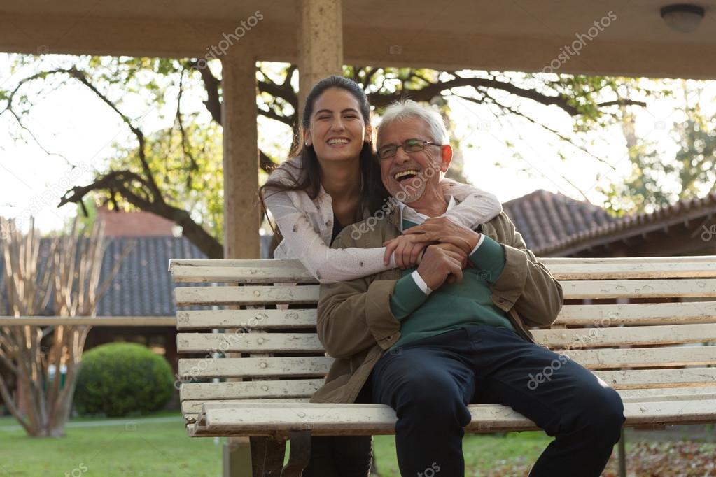 Young woman with her grandfather in park