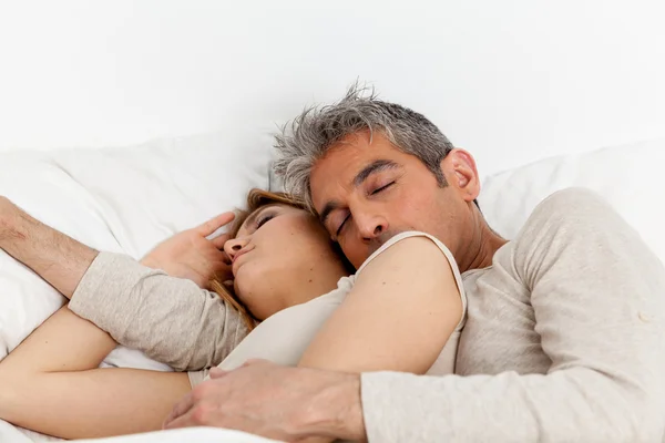 Abraçando casal dormindo na cama — Fotografia de Stock