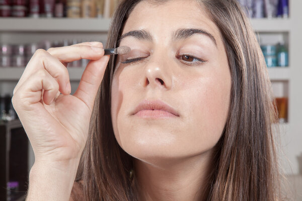 Woman applying eye shadow itself