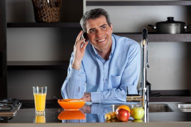 Telefon üzerinde breackfast mutfak konuşan adam