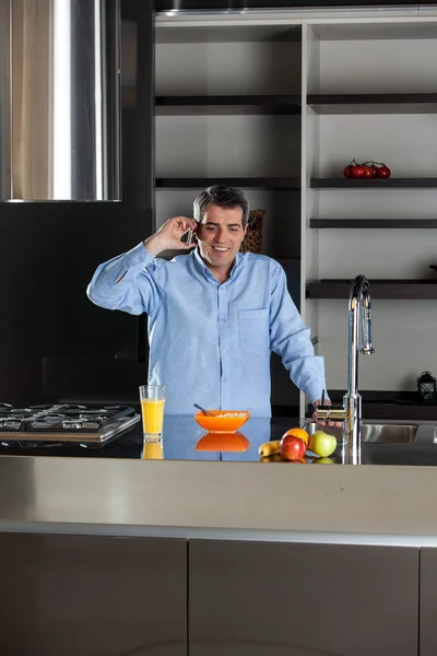 Homem falando telefone na cozinha — Fotografia de Stock