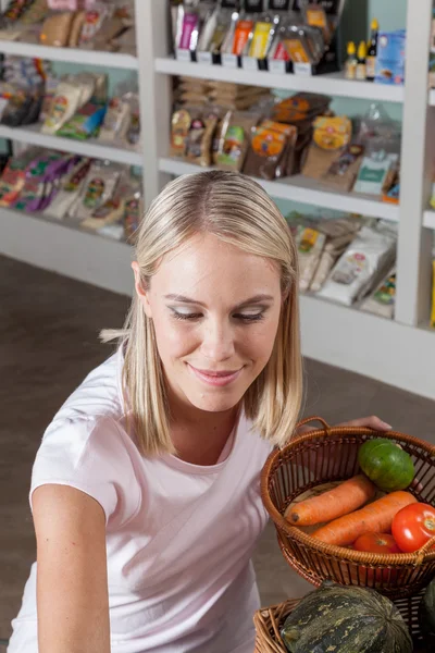 Frau kauft Gemüse ein — Stockfoto