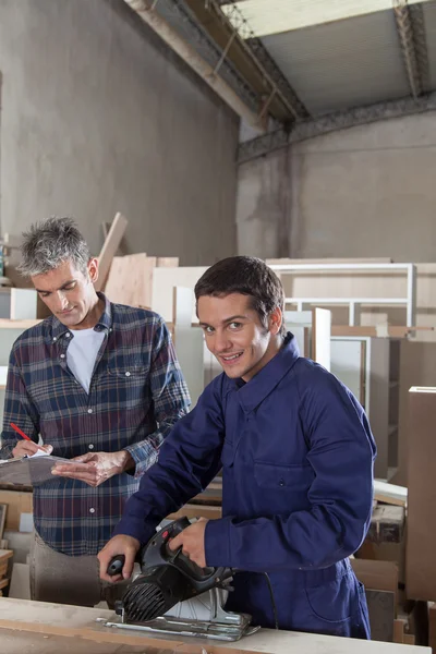 The carpenter with his assistant — Stock Photo, Image