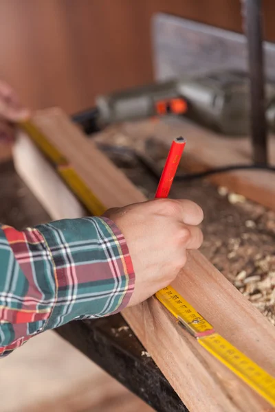 Ξυλουργός μέτρηση ένα κομμάτι ξύλου — Φωτογραφία Αρχείου