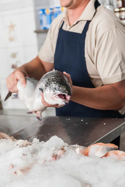 Venditore con un salmone rosa — Foto Stock