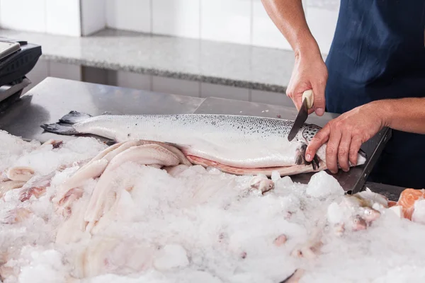 Hombre cortando un salmón rosa — Foto de Stock