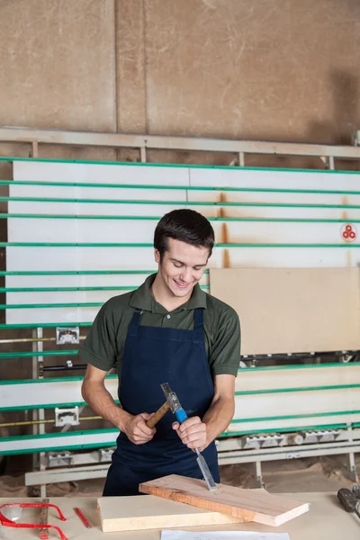 Happy carpenter working with a chisel — Stock Photo, Image