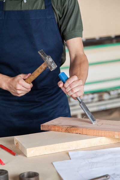 Carpenter working with a chisel