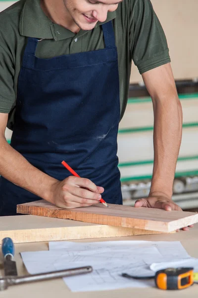 Smiling carpenter in his desk — Stock Photo, Image