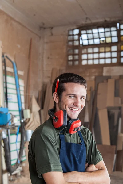 Carpenter smiling with protectors hearing — Stock Photo, Image