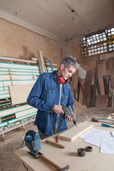 Hombre trabajando con un taladro — Foto de Stock