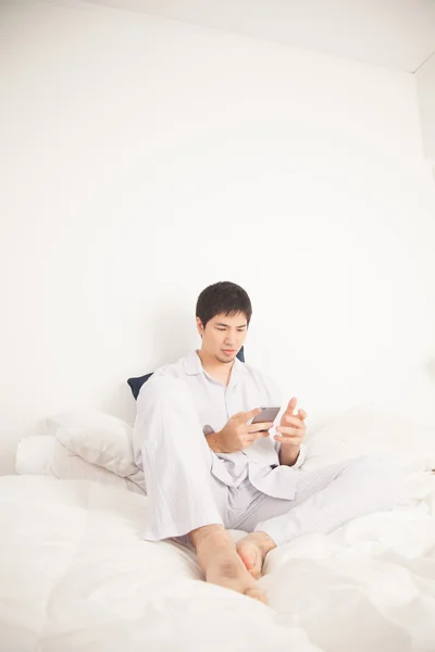 Asian man using mobile phone — Stock Photo, Image