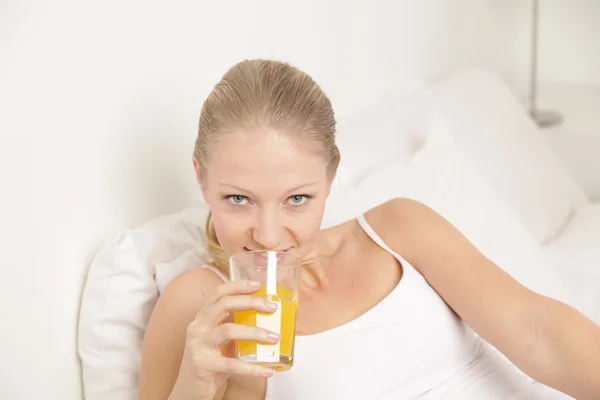 Young woman drinking a juice Stock Picture