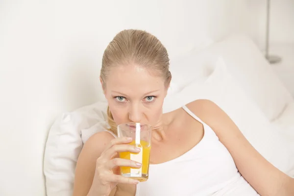 Young woman drinking a juice Royalty Free Stock Images