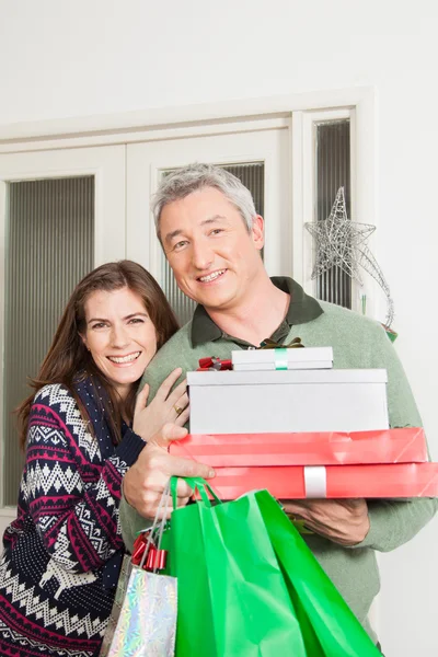 Parents hoding a lot of presents — Stock Photo, Image