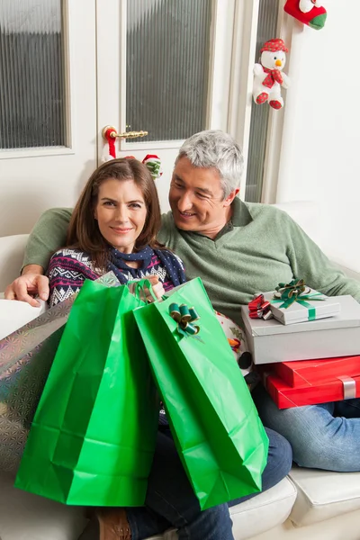 Couple in the sofa with presents — Stock Photo, Image